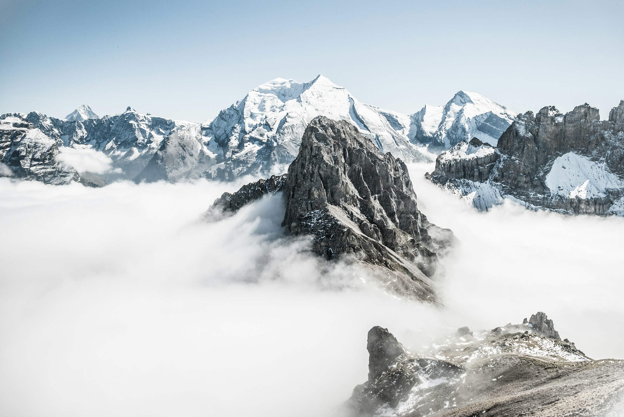 A ridge breaking through a sea of cloud at first light